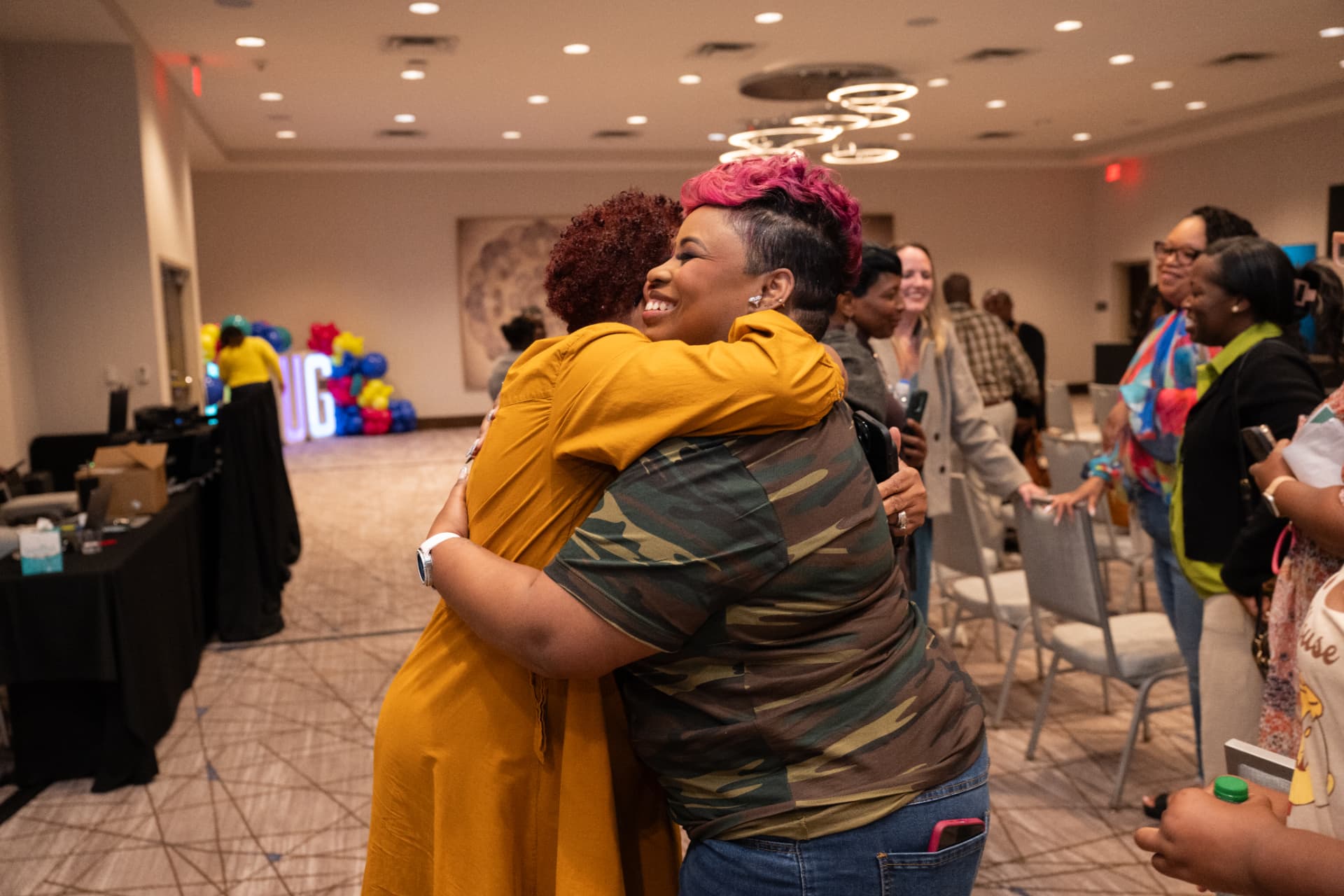 LaShawn sharing a hug with an attendee at UNPLUG